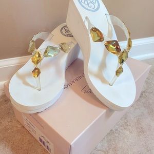 White BCBG Generation thong wedge sandals.